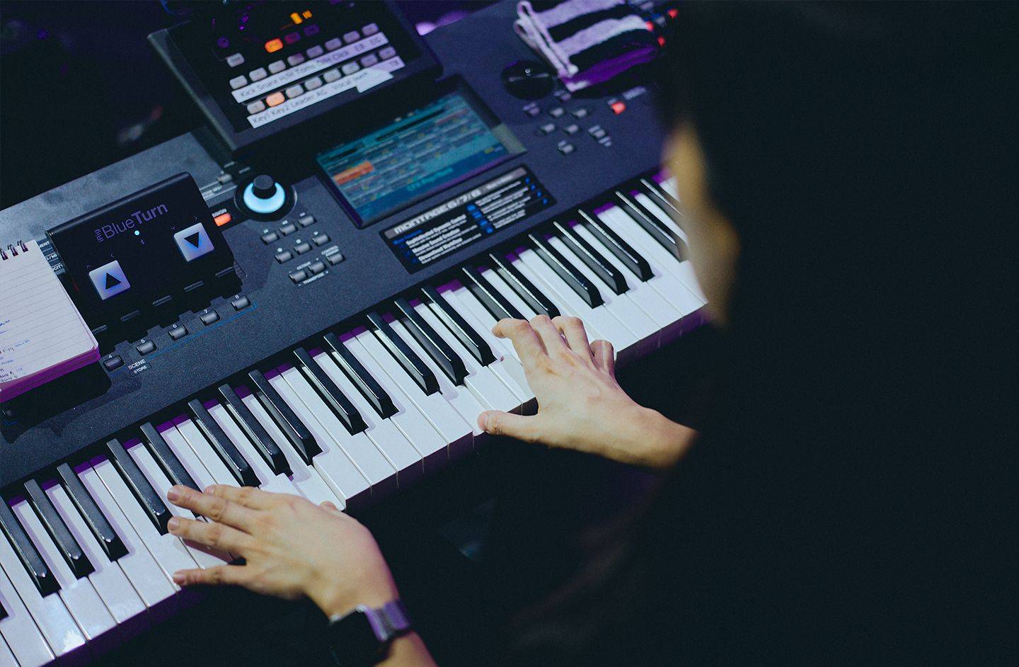 Picture of a Korean musician playing a keyboard