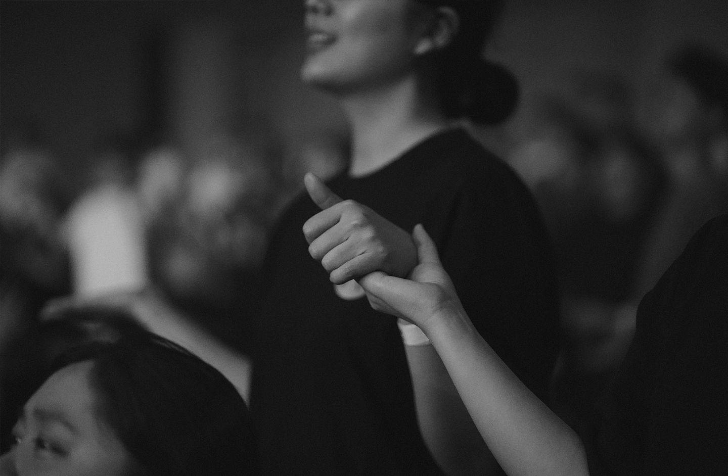 Picture of Korean worshippers holding hands during worship